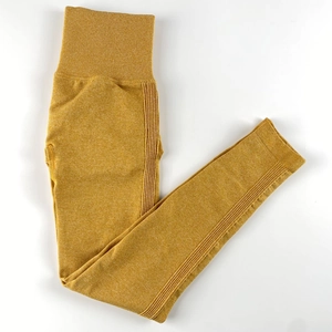 Close-up of mustard yellow seamless yoga leggings with ribbed texture and high waistband