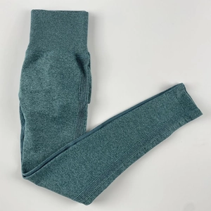 Detailed flat lay of high-waisted seamless yoga pants in deep teal with heathered texture