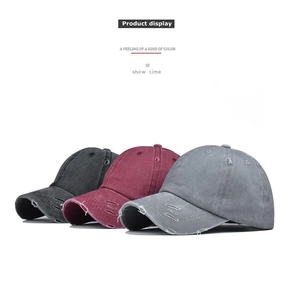 Detail showing distressed washed cotton baseball caps in black, burgundy and grey colors