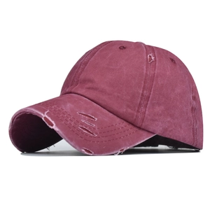 Side view of distressed burgundy baseball cap with vintage washed texture and ripped detail