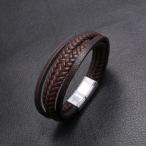 Detail of multi-layer brown braided leather bracelet with silver magnetic metal clasp