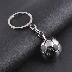 Detailed view of metal football keychain pendant with realistic stitched texture on leather