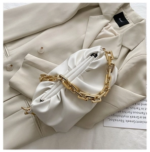 Detail of white pleated cloud bag in soft PU leather with chunky gold chain strap