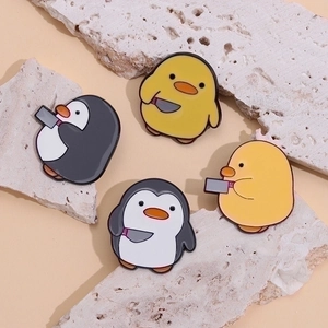 Cute enamel penguin and duck pins with knives on decorative stones for backpacks
