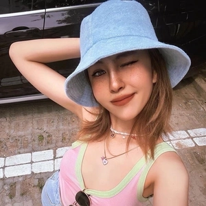 Outdoor lifestyle shot of a light blue terry cloth bucket hat for men and women