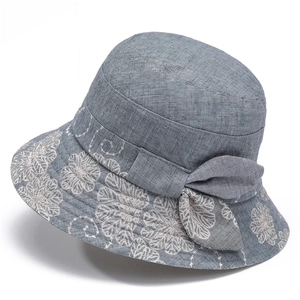Women's sun hat with floral embroidery and bow detail in greyish-blue cotton linen