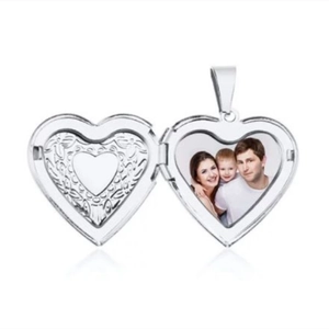 Macro shot of silver heart locket pendant showing interior photo frame and engraving