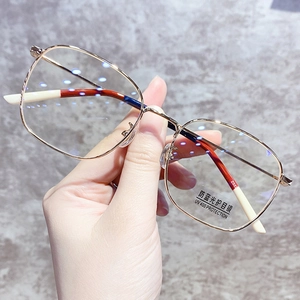 Detail of rose gold metal eyewear frame with tricolor temple tips and blue light lenses
