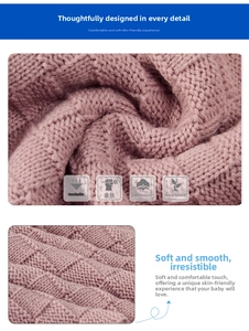 Detail of pink knitted baby blanket showing breathable waffle texture and soft fabric