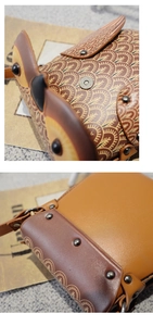 Detail view of owl shaped crossbody bag with vintage embossed leather and metal rivets
