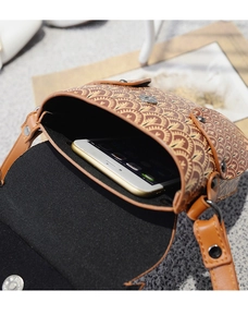 Detail of printed crossbody phone bag showing interior capacity and magnetic closure