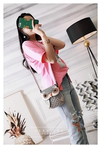 Fashionable owl crossbody bag with 3D eyes shown on a model in a cozy interior