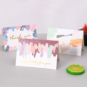 Three premium greeting cards with gold foil lettering thank you on light background