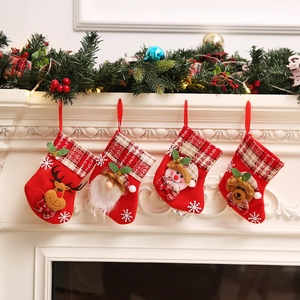 Christmas stockings set with Santa reindeer and snowman hanging on a festive fireplace mantel