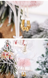 Detail of pink Christmas angel ornament showing gold glitter boots and plush feather skirt