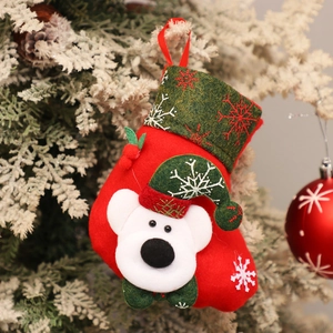 Detail of red Christmas stocking with white polar bear and snowflake felt pattern