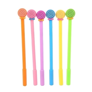 Set of six colorful lollipop gel pens with silicone toppers on white background