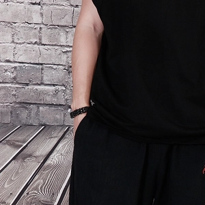 Close-up of double-layered titanium steel biker bracelet on a male model wrist