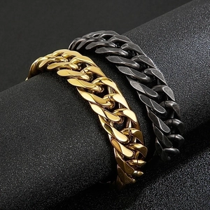 Polished gold and matte black stainless steel Cuban link bracelets on display stands