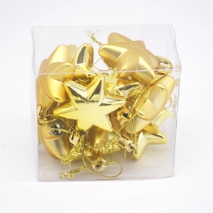 Set of shiny gold star Christmas tree ornaments with hanging loops in a clear gift box