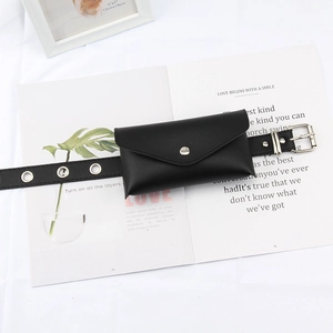 Detail of black faux leather envelope belt bag with silver grommets and metal buckle