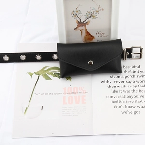 Detail of a black PU leather envelope waist bag with silver snap button and eyelet belt