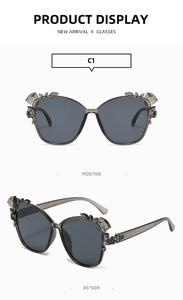 Detailed macro view of cat eye sunglasses with crystal floral accents and dark lenses