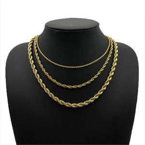 Detailed view of layered gold rope chains in various lengths on a black bust display