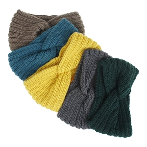 Detail showing the knitted texture and twisted design of headbands in five different colors