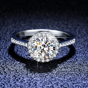 Macro shot of a classic silver halo moissanite ring with sparkling round center stone