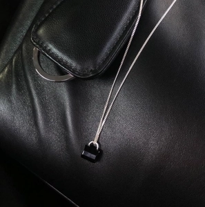 Detailed close-up of S925 sterling silver mini padlock necklace with black zircon pendant