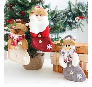 Detail of Christmas stockings featuring Santa, reindeer, and snowman plush characters
