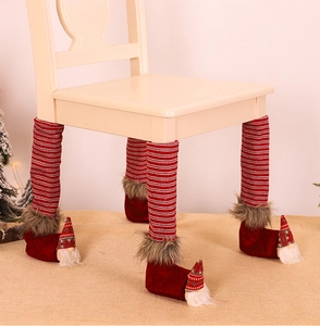 Close-up of gnome-style Christmas chair leg covers with red stripes and faux fur