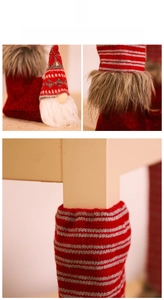 Close-up of Christmas gnome chair leg covers with striped knit texture and gnome decor