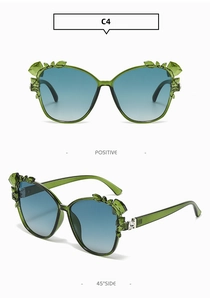 Detailed views of emerald green cat eye sunglasses with leaf crystal accents and blue lenses