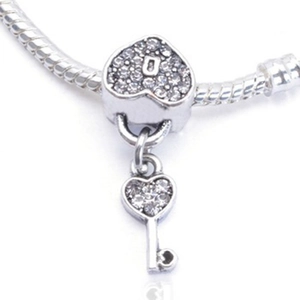 Silver heart lock and key charm pendant with white rhinestones on snake chain bracelet