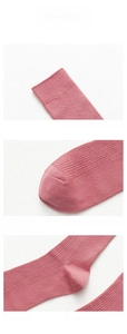 Detail view of pink ribbed cotton socks showing elastic cuff, heel, and reinforced toe
