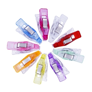 Colorful heart-shaped transparent plastic clips arranged in a circle on white background
