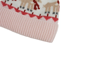 Close-up of knit texture on pink and white winter hat with reindeer jacquard pattern