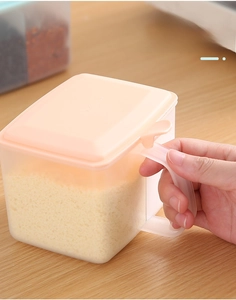 Detail of semi-transparent seasoning box with ergonomic orange handle for easy grip