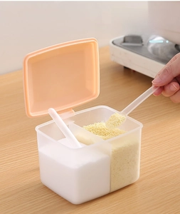 Detail view of seasoning box with individual spoons and orange lid for easy scooping