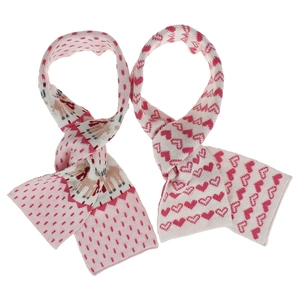 Détail macro d'écharpes en tricot rose avec cœurs rouges et motifs jacquard de rennes