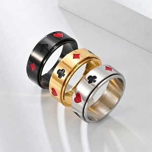 Detail shot of spinner rings with poker card patterns in black, gold, and silver finishes