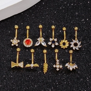 Set of 11 golden navel rings featuring butterfly flower and snowflake zircon designs