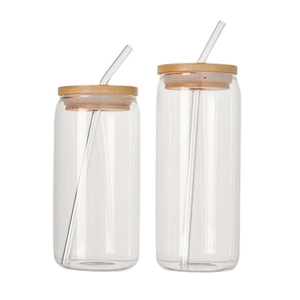 Set of two clear glass can cups with bamboo lids and matching glass straws on white background