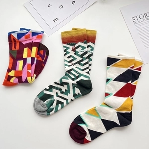 Three pairs of French oil painting cotton socks with colorful geometric patterns on a white table