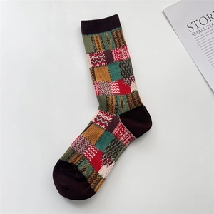 Detailed view of colorful patchwork pattern and knit textures on mid-calf cotton socks