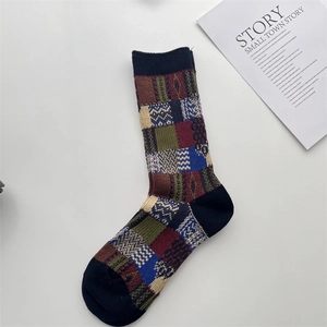 Detail of vintage patchwork crew socks featuring geometric knit patterns in navy and burgundy