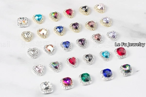 Close-up of heart and square crystal nail charms with gold and silver frames