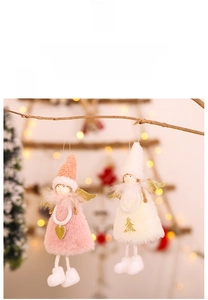 Detail of plush Christmas angel ornaments with pink and white fur and gold sequin wings